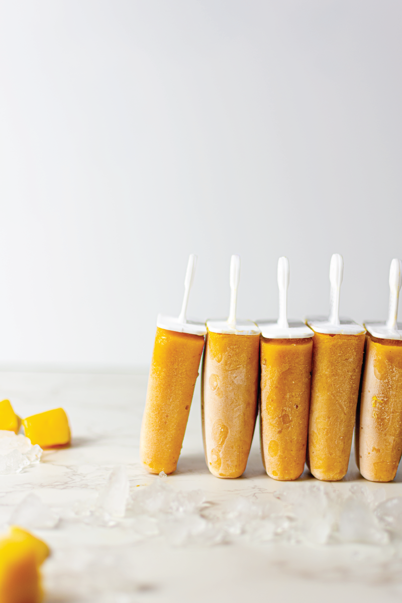 Mango popsicles surrounded by ice