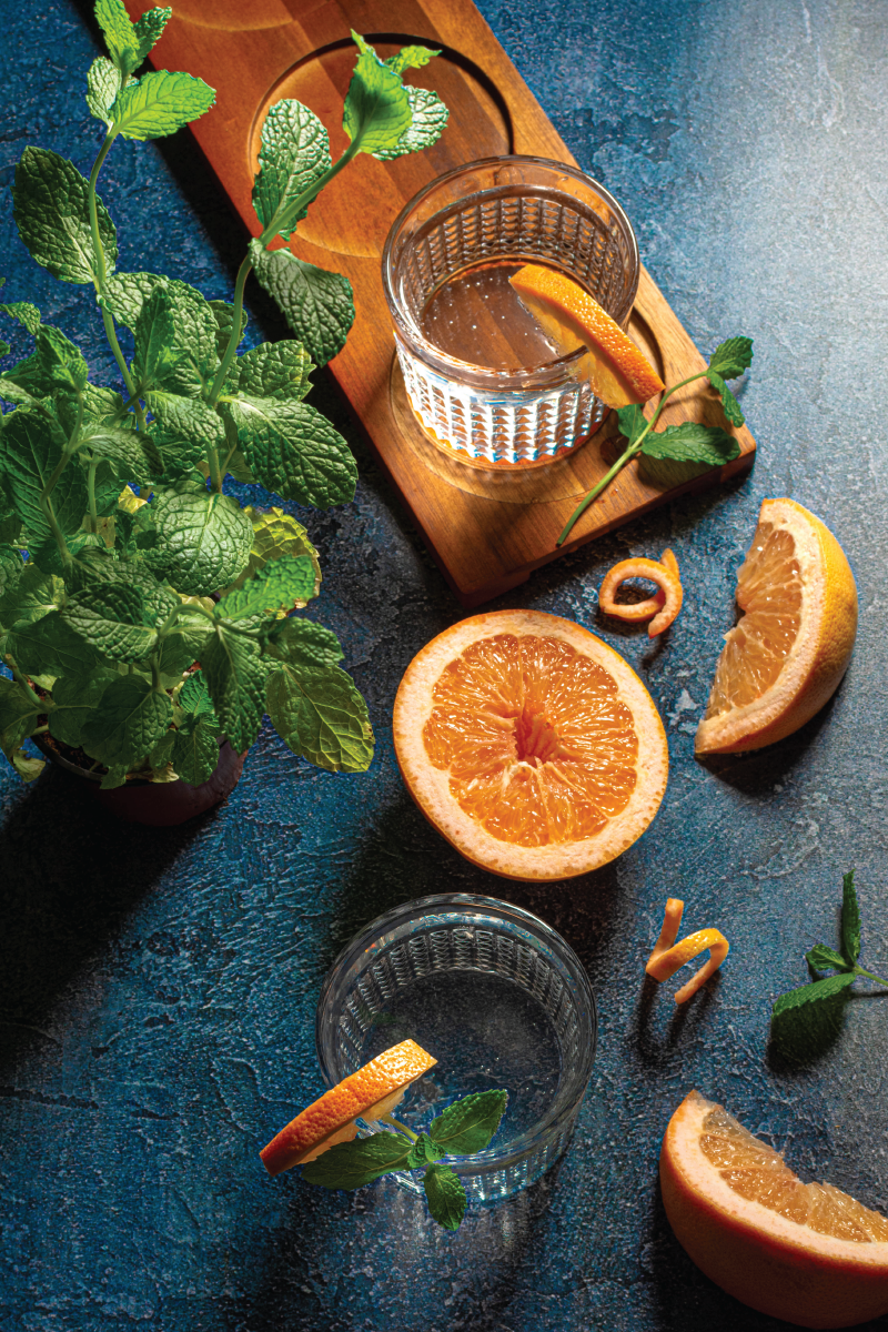 An overhead shot of a classic cocktail with grapefruit and mint